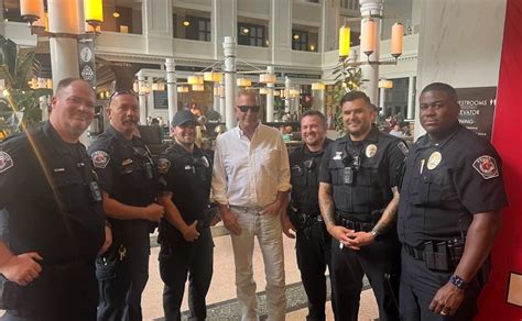 Kevin Costner snaps a photo with RTD police at Union Station